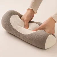 Hands pressing into the buckwheat hull and foam fill